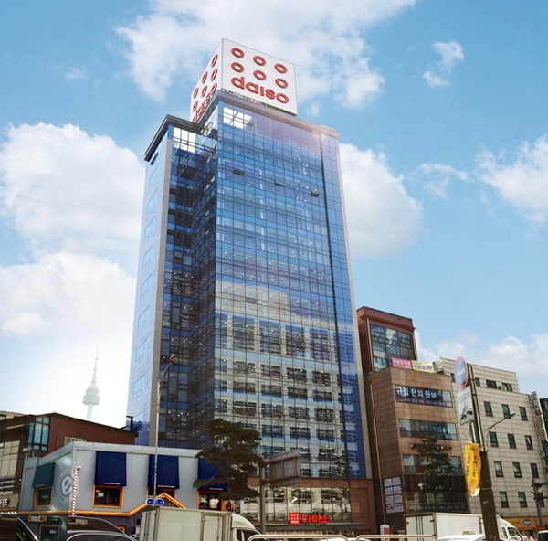 The famous 12-story Daiso building near Myeongdong Station in Seoul, with the N Seoul Tower visible in the background.